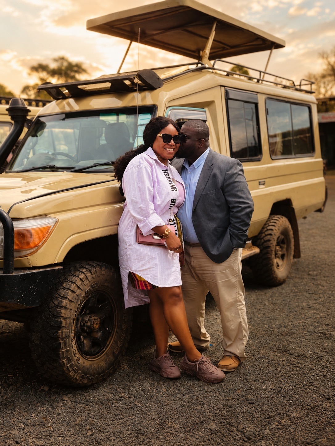 Christabel and Abiola beside a safari vehicle
