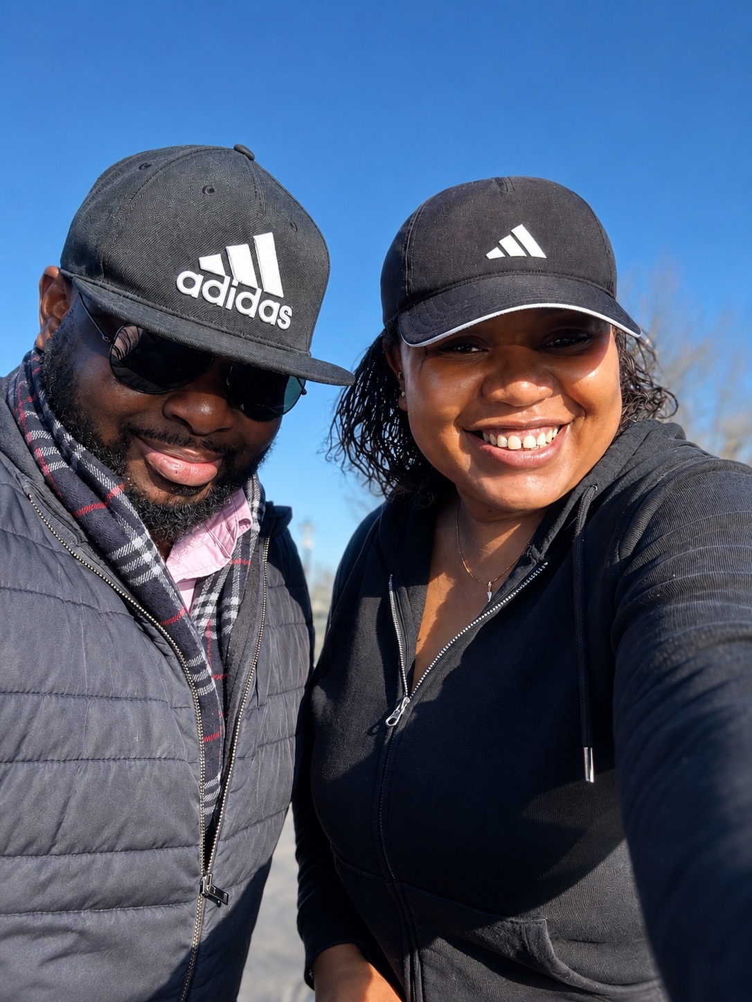 Christabel and Abiola smiling outdoors on a winter day